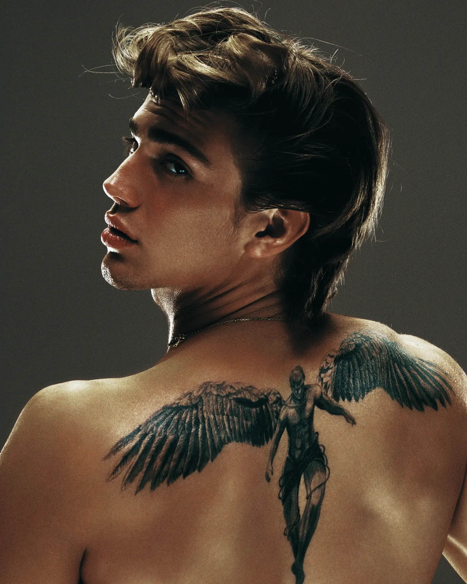 Vinnie Hacker portrait with neck tattoo and wing back piece