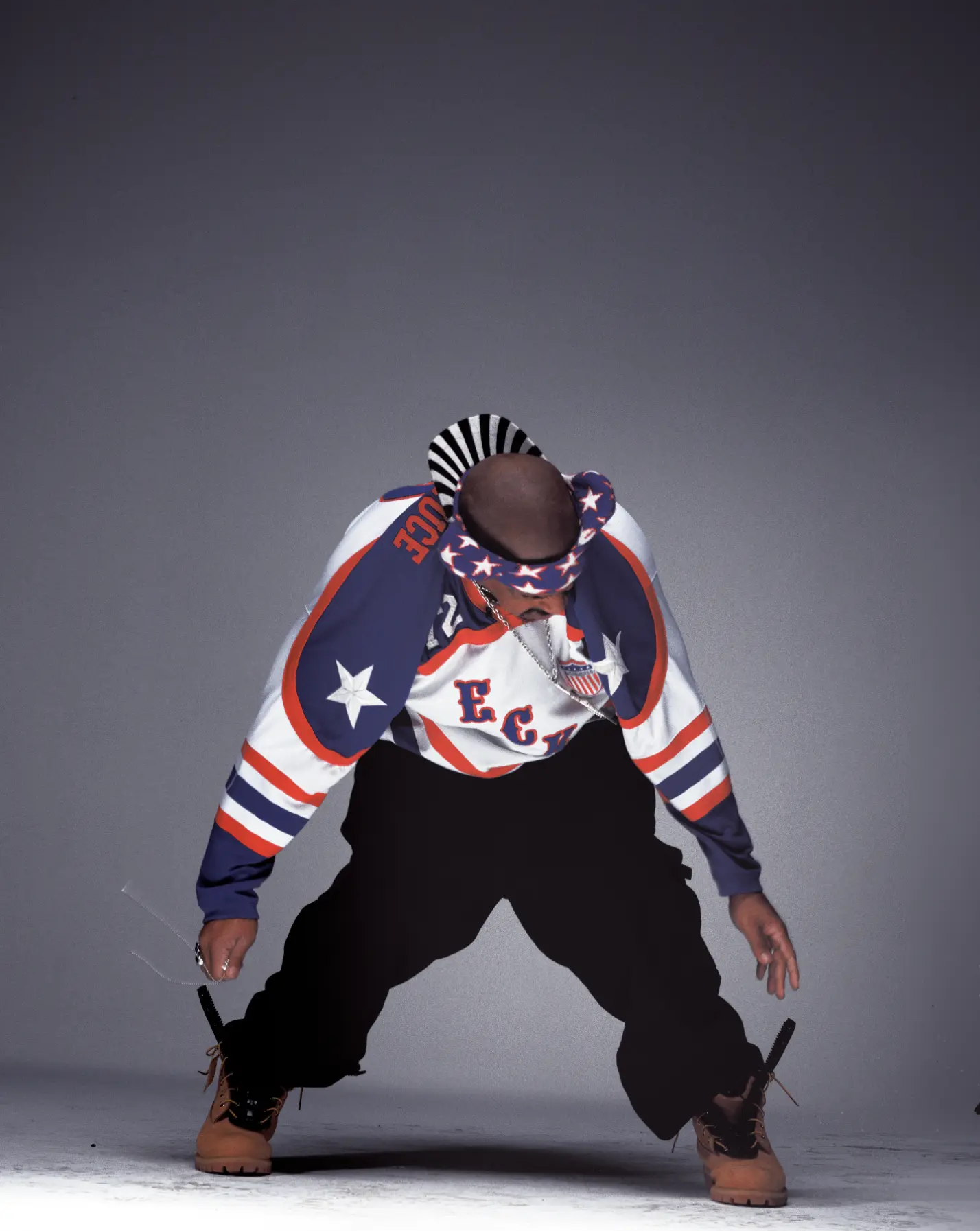 Figure in hockey jersey bent forward with boots