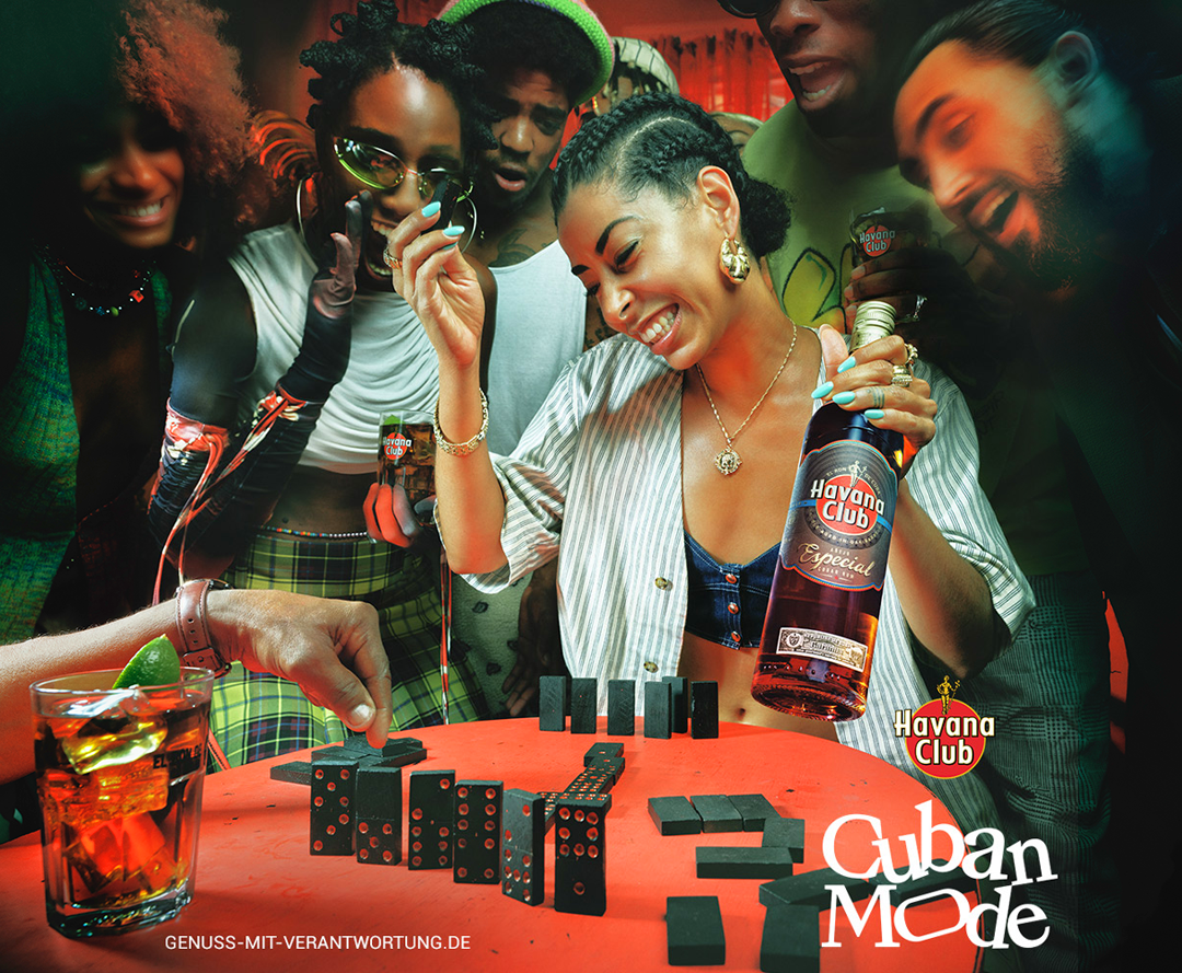 Havana Club — Cuban Mode campaign, group around red table with dominoes and rum bottle