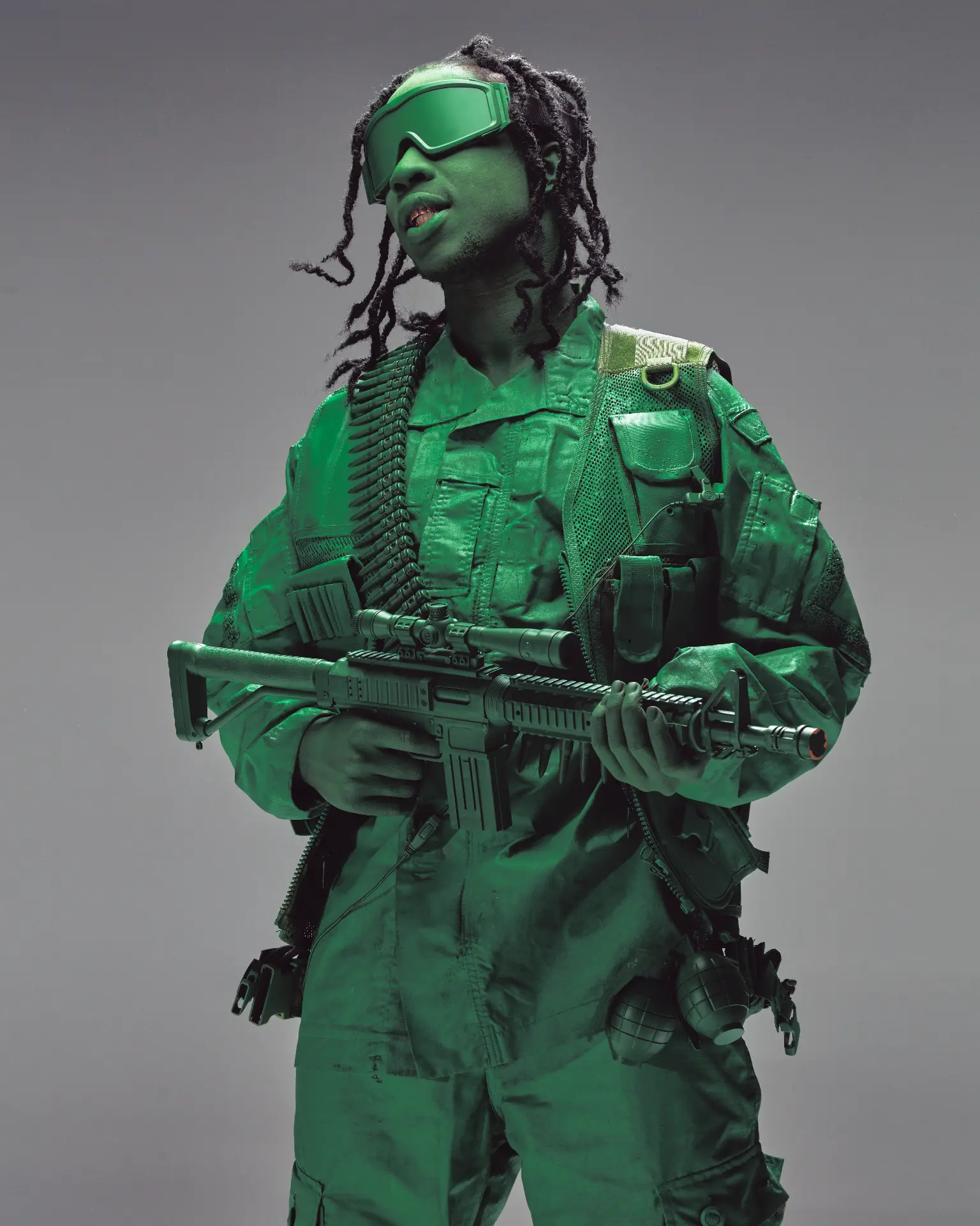 Soldier in green tactical gear holding a rifle
