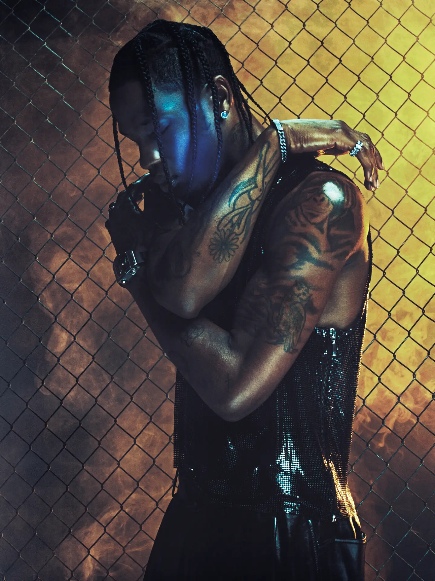 Travis Scott — chain-link fence portrait with warm backlight
