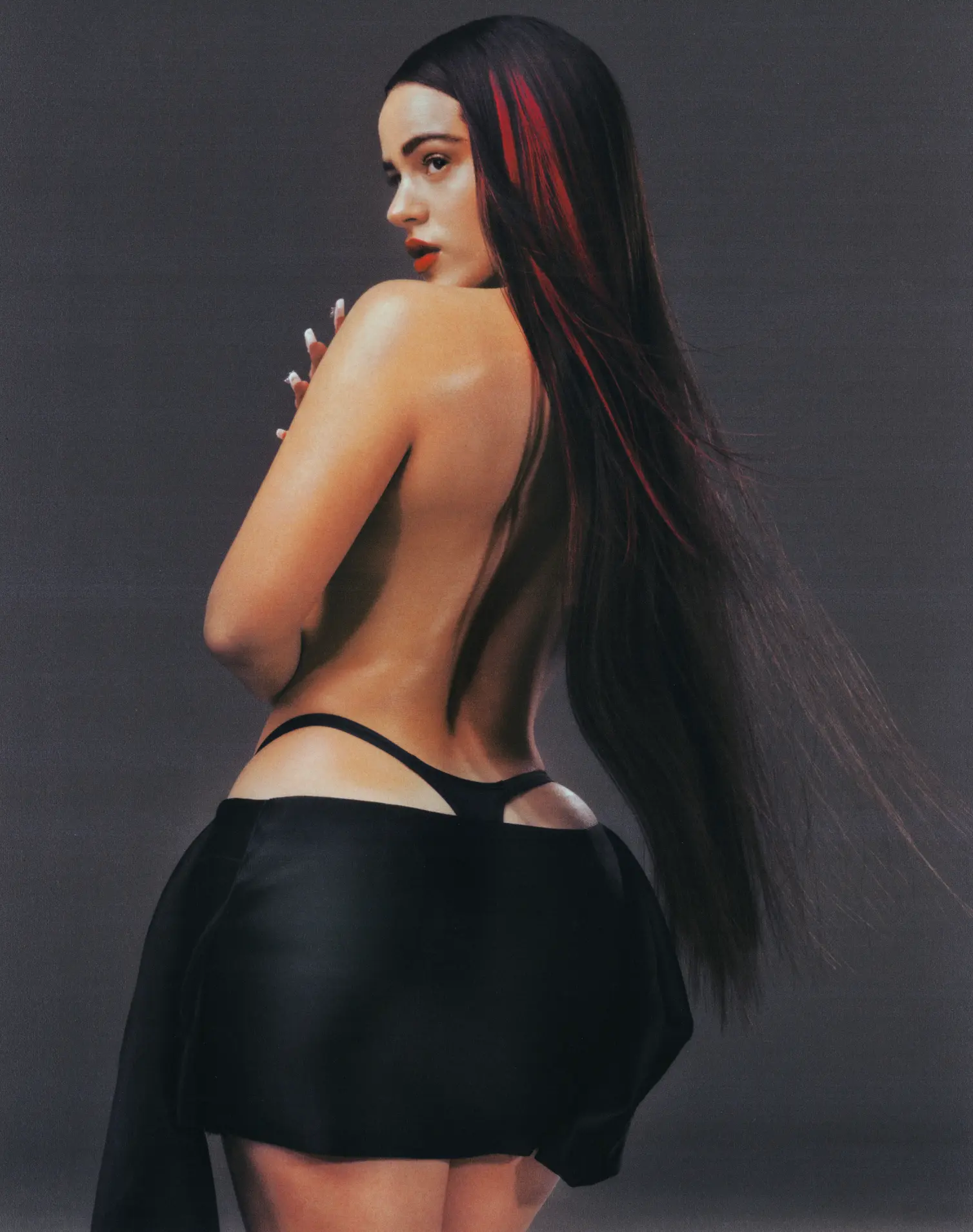ROSALIA x GQ Cover Story — portrait from behind with red-streaked hair