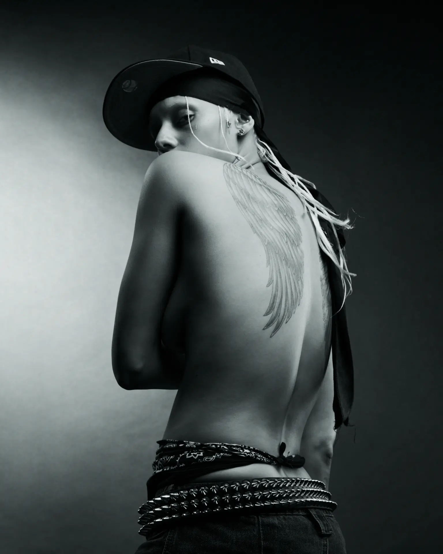 Jazzelle portrait with wing back tattoo and cap
