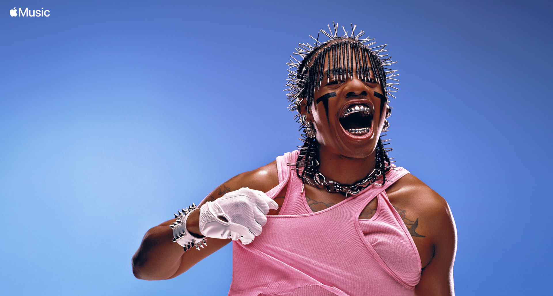 Teezo Touchdown — Apple Music portrait in pink tank top, spiked hair and white glove against blue sky