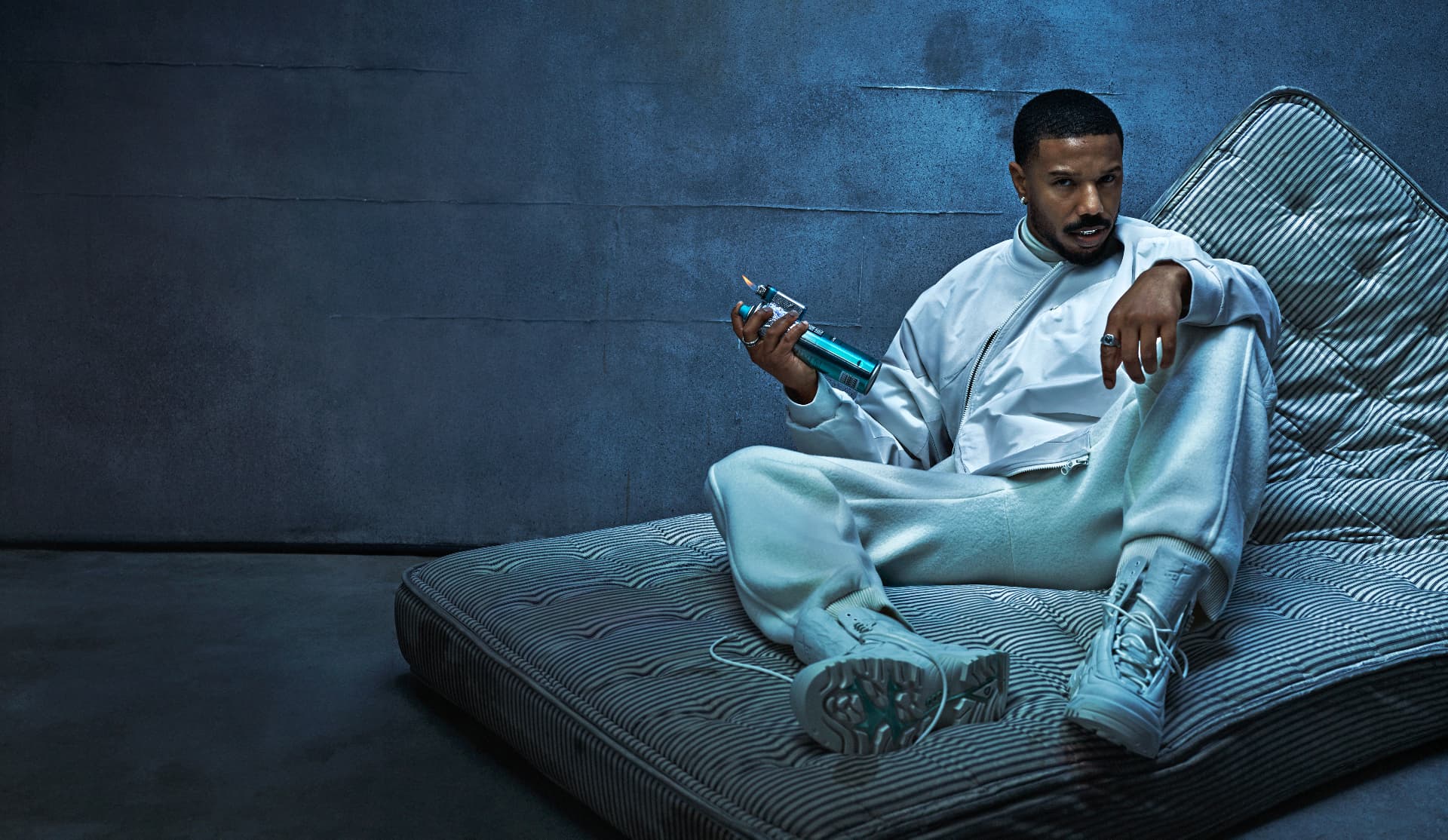 Michael B Jordan — reclining on mattress with spray can