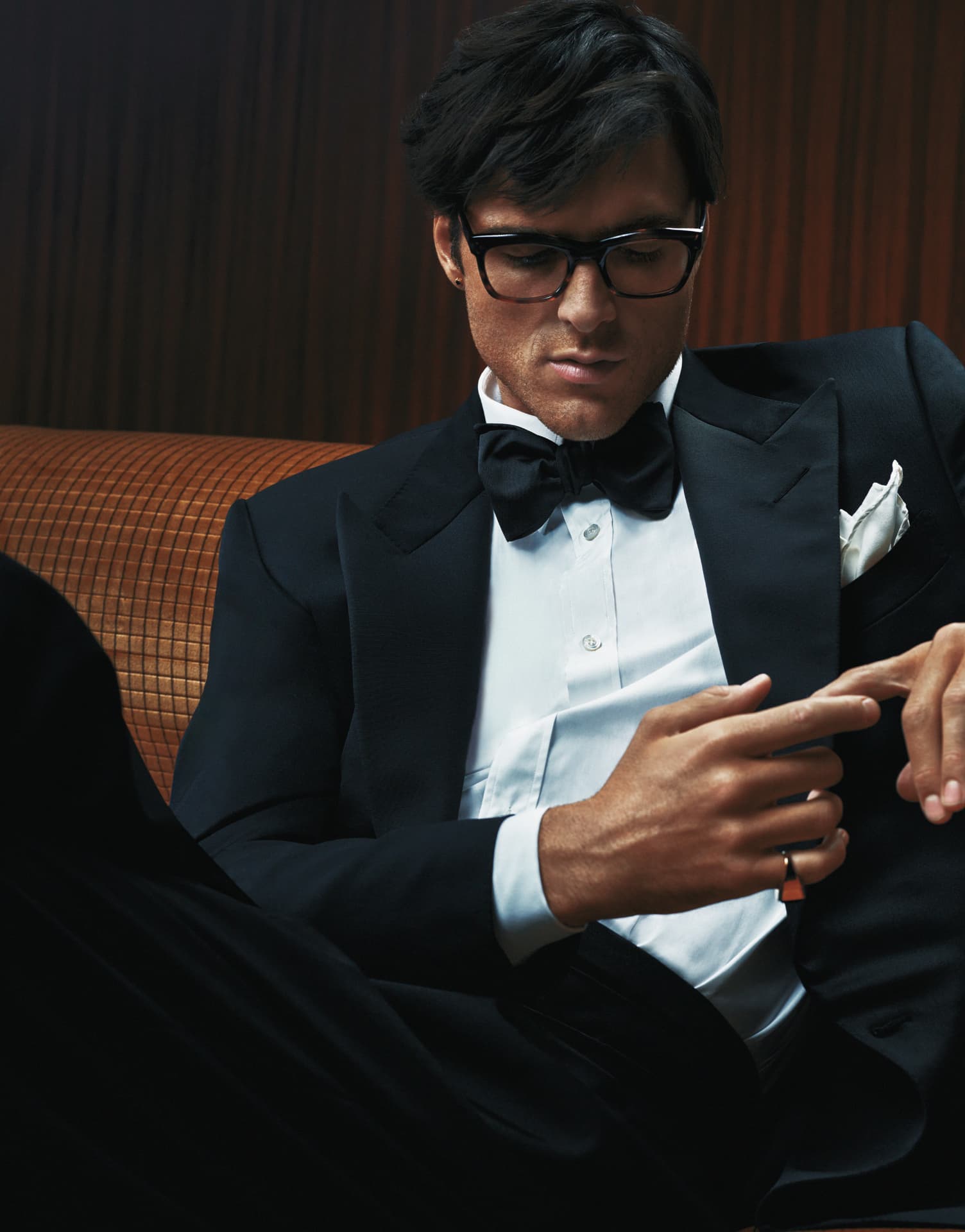 Jacob Elordi — seated in tuxedo adjusting cuff