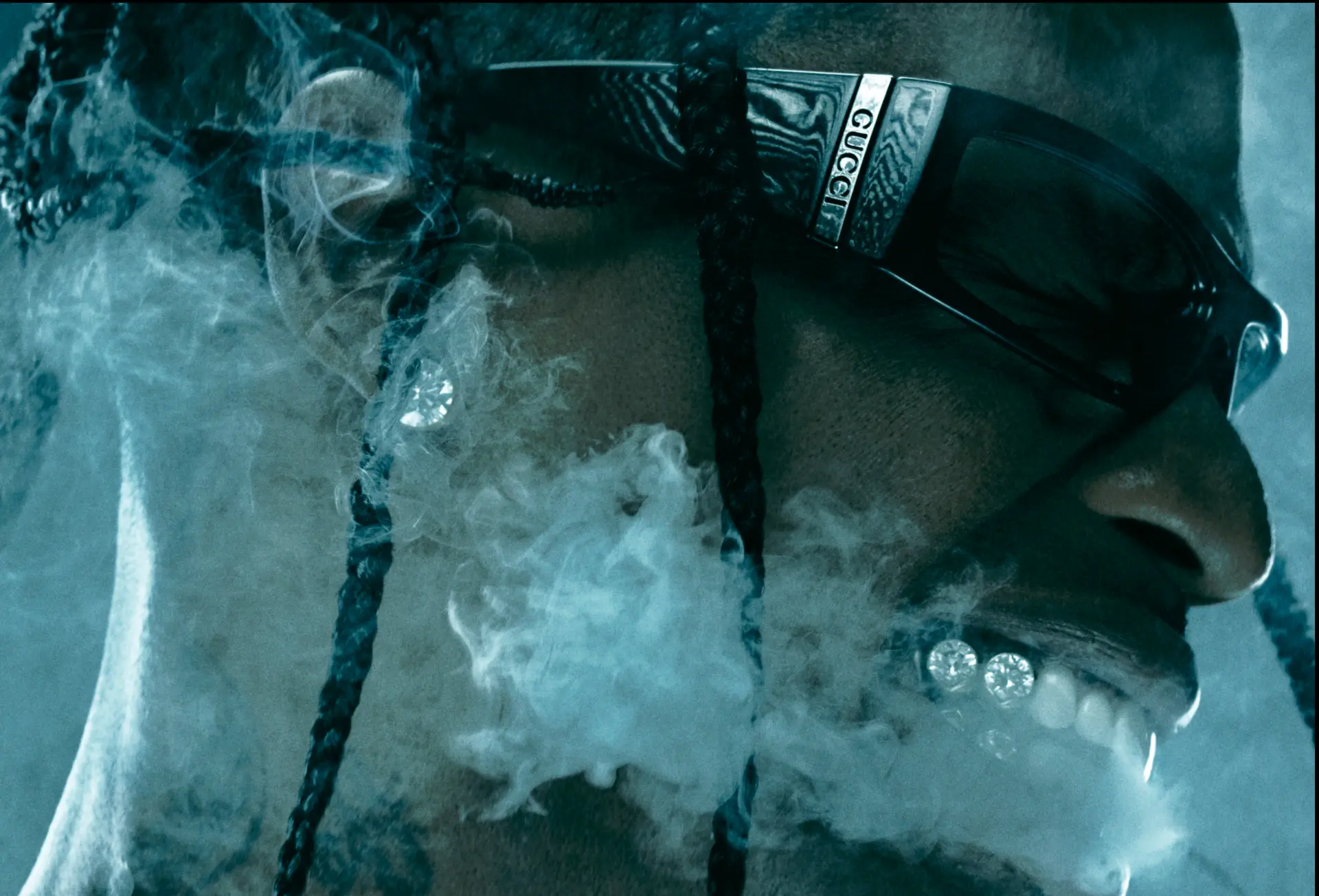 Travis Scott — close-up with Gucci belt and smoke