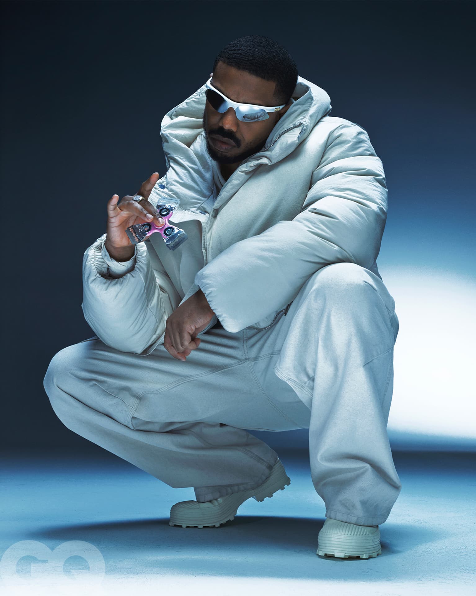 Michael B Jordan — crouching in cream puffer
