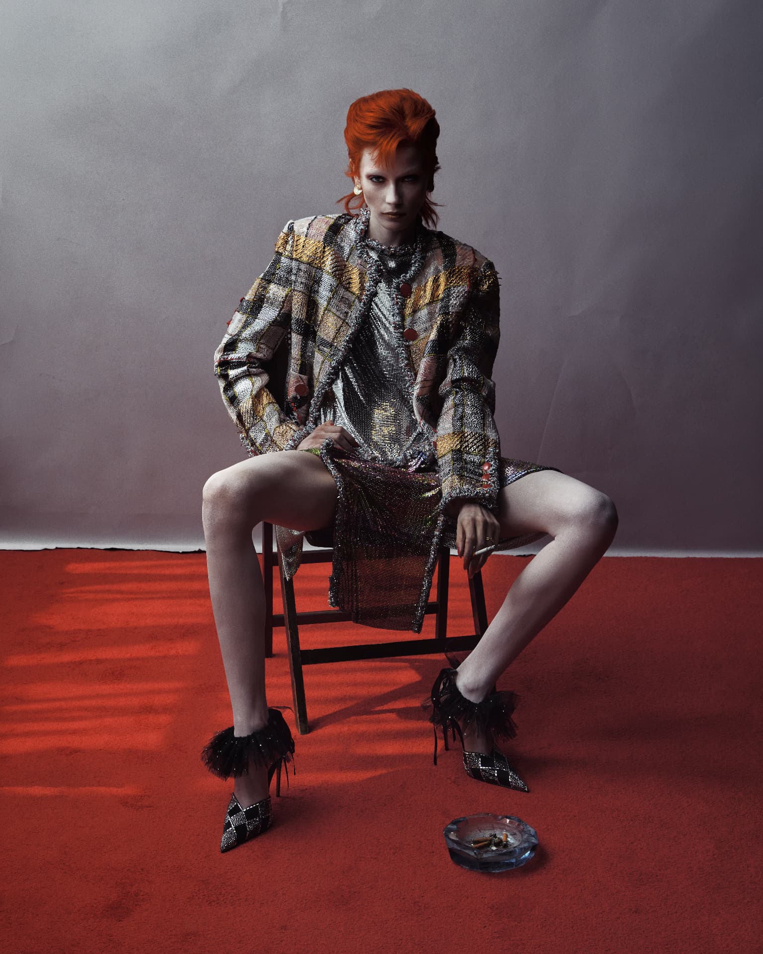 ZIGGY — sequined jacket seated on red floor with ashtray