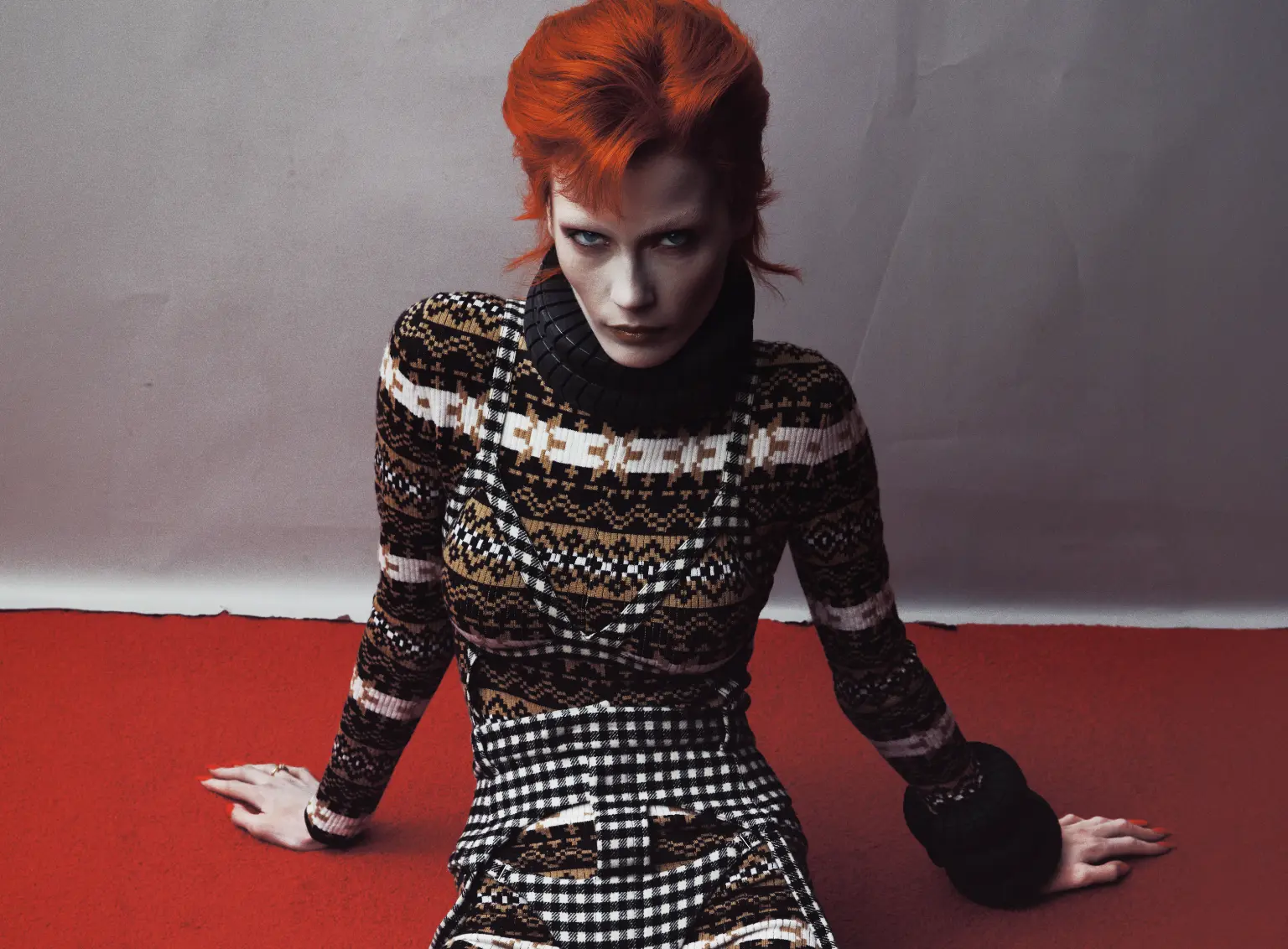 ZIGGY — red-haired figure in patterned knit on red floor