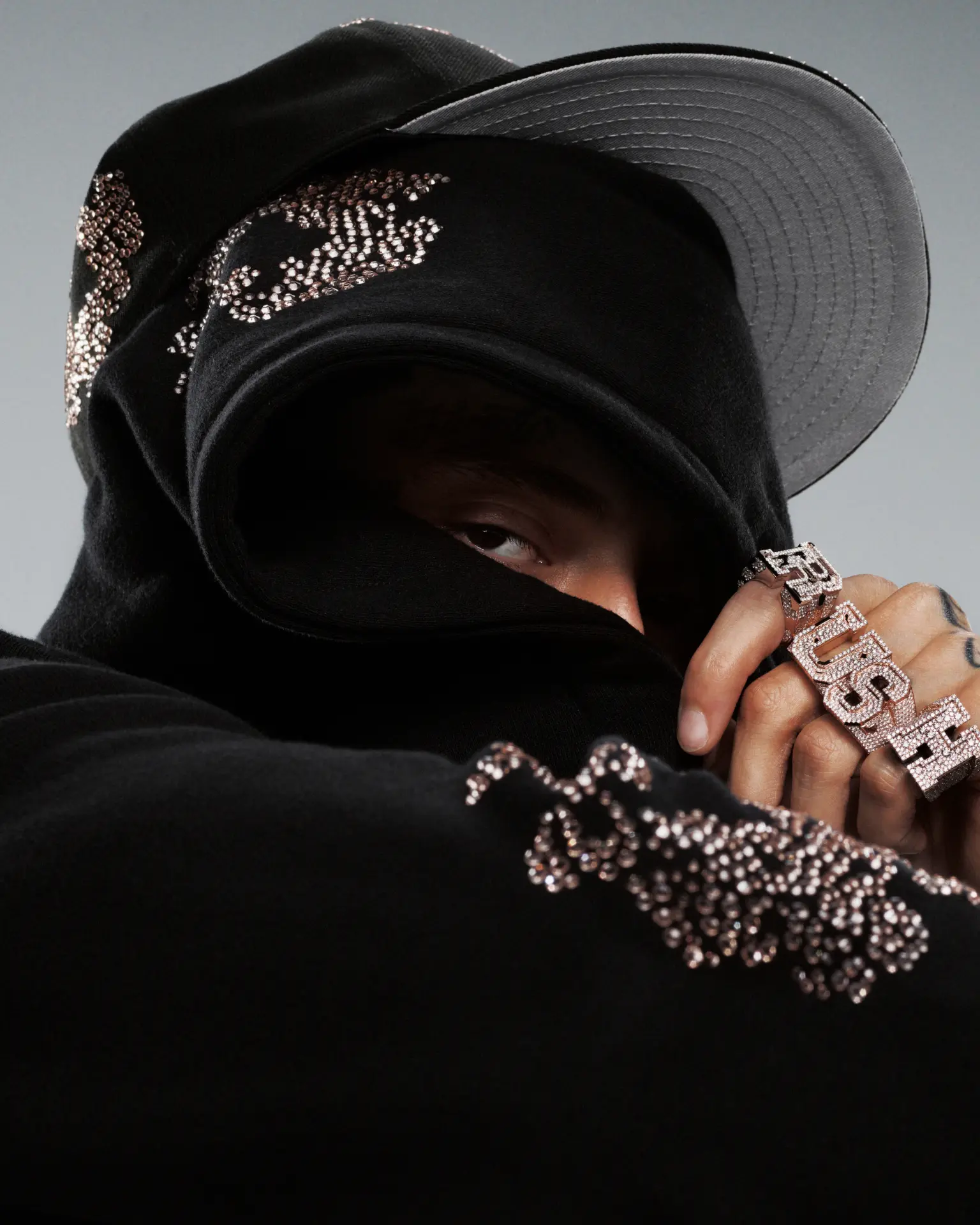 Central Cee — masked portrait in black balaclava and bucket hat with rings