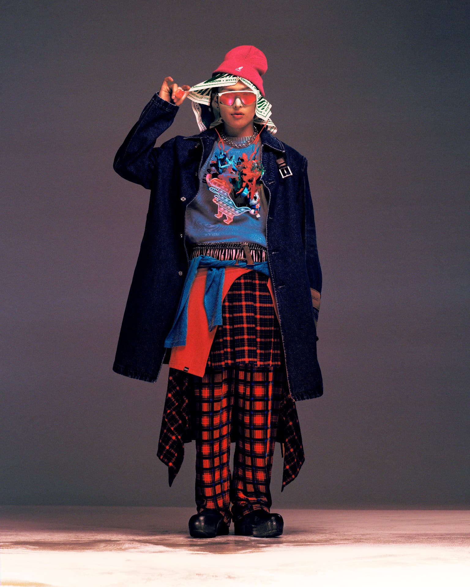 ATEEZ — figure in pink beanie and layered plaid streetwear