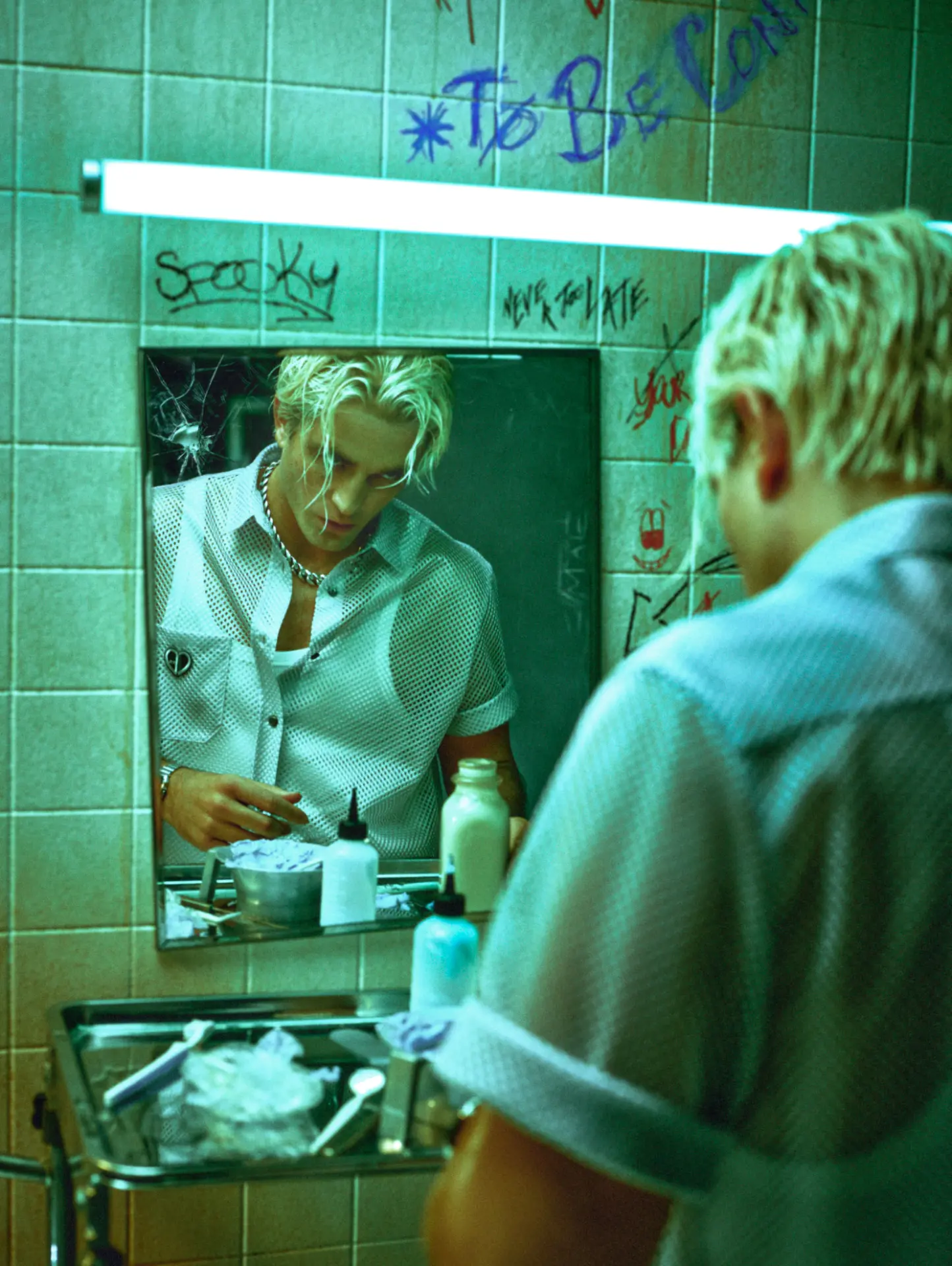 Rob Pattinson GQ — bathroom mirror portrait in green-blue light