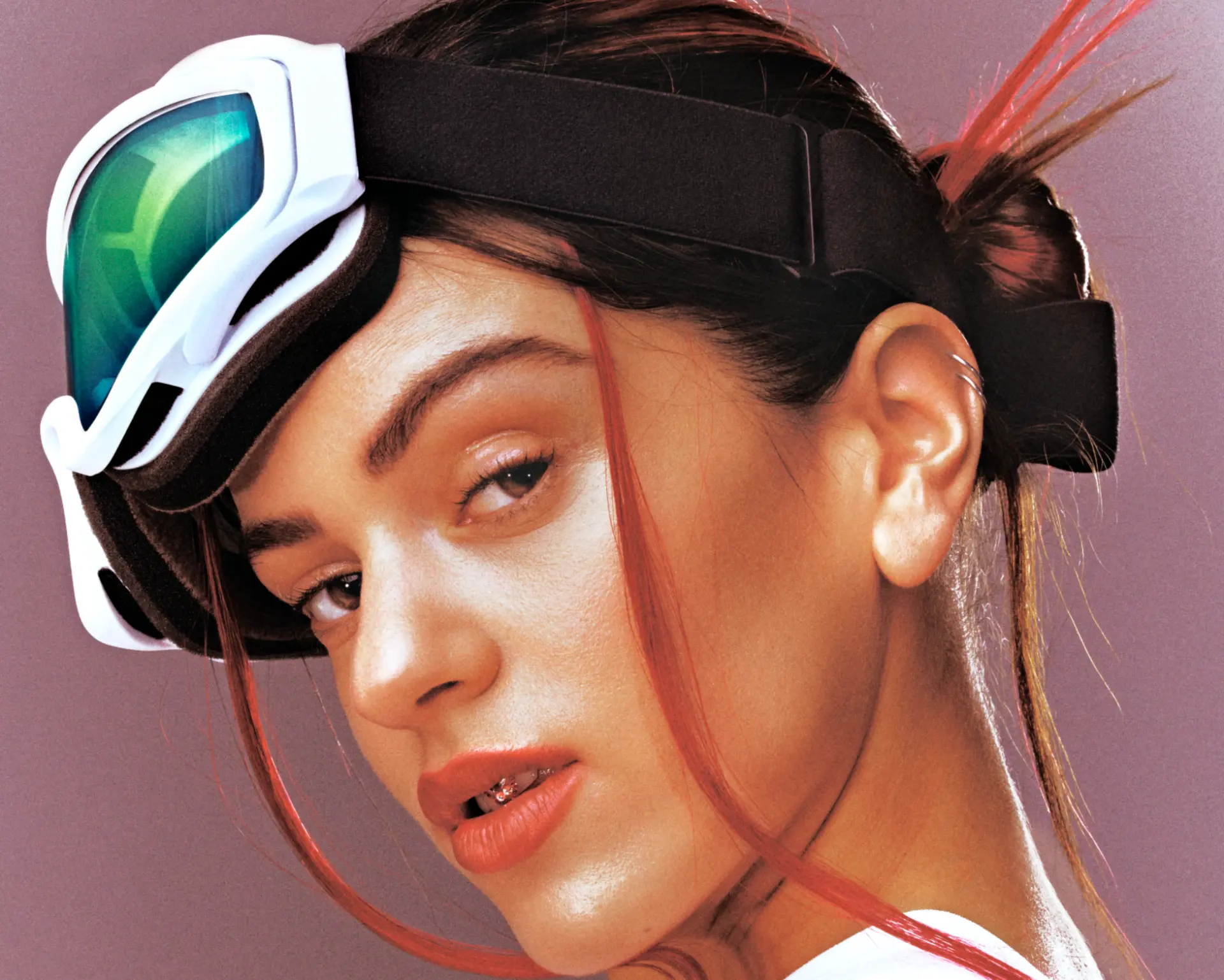 ROSALIA x GQ Cover Story — close-up portrait with white ski goggles and red-streaked hair against mauve