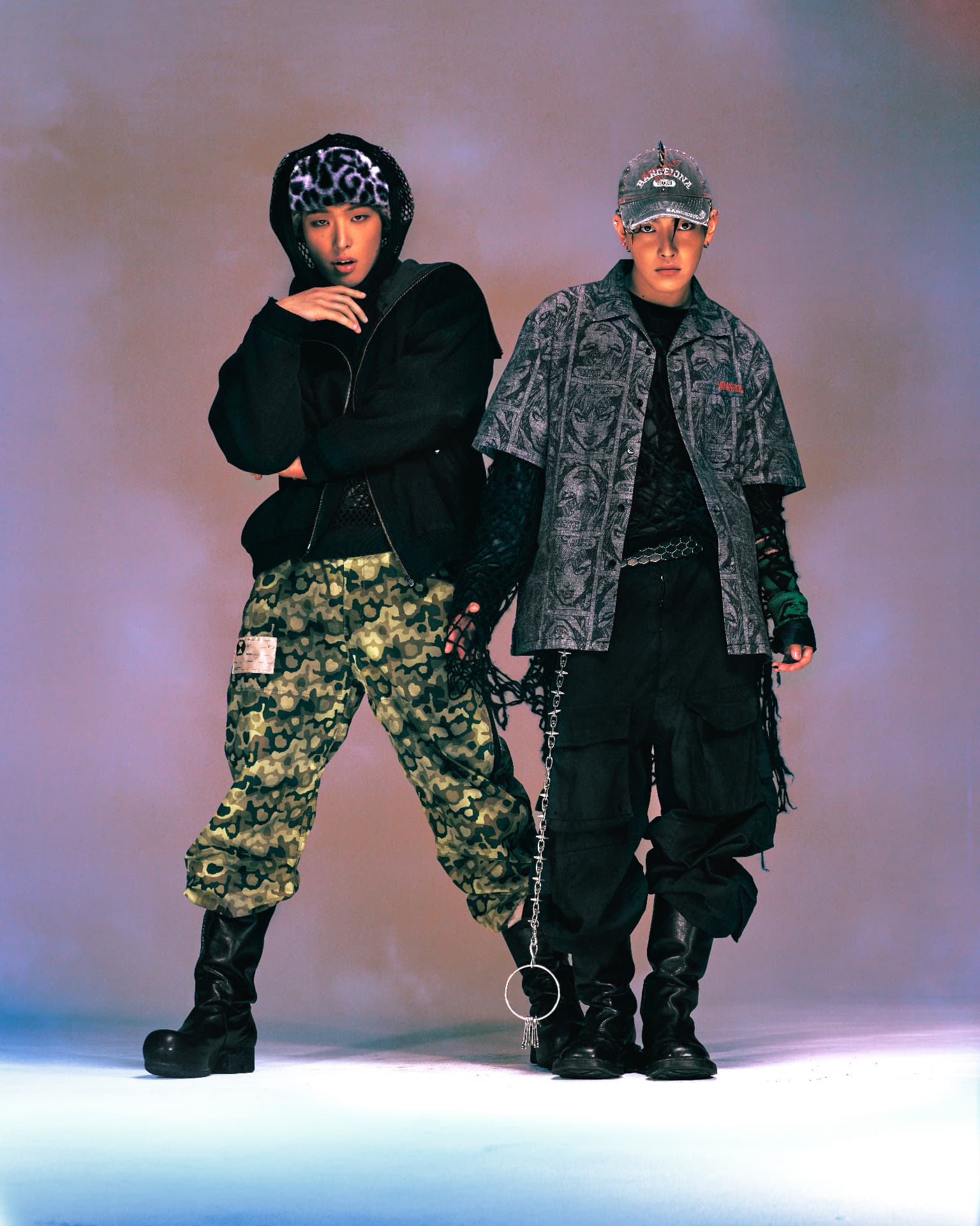 ATEEZ — two members in graphic streetwear and camouflage trousers