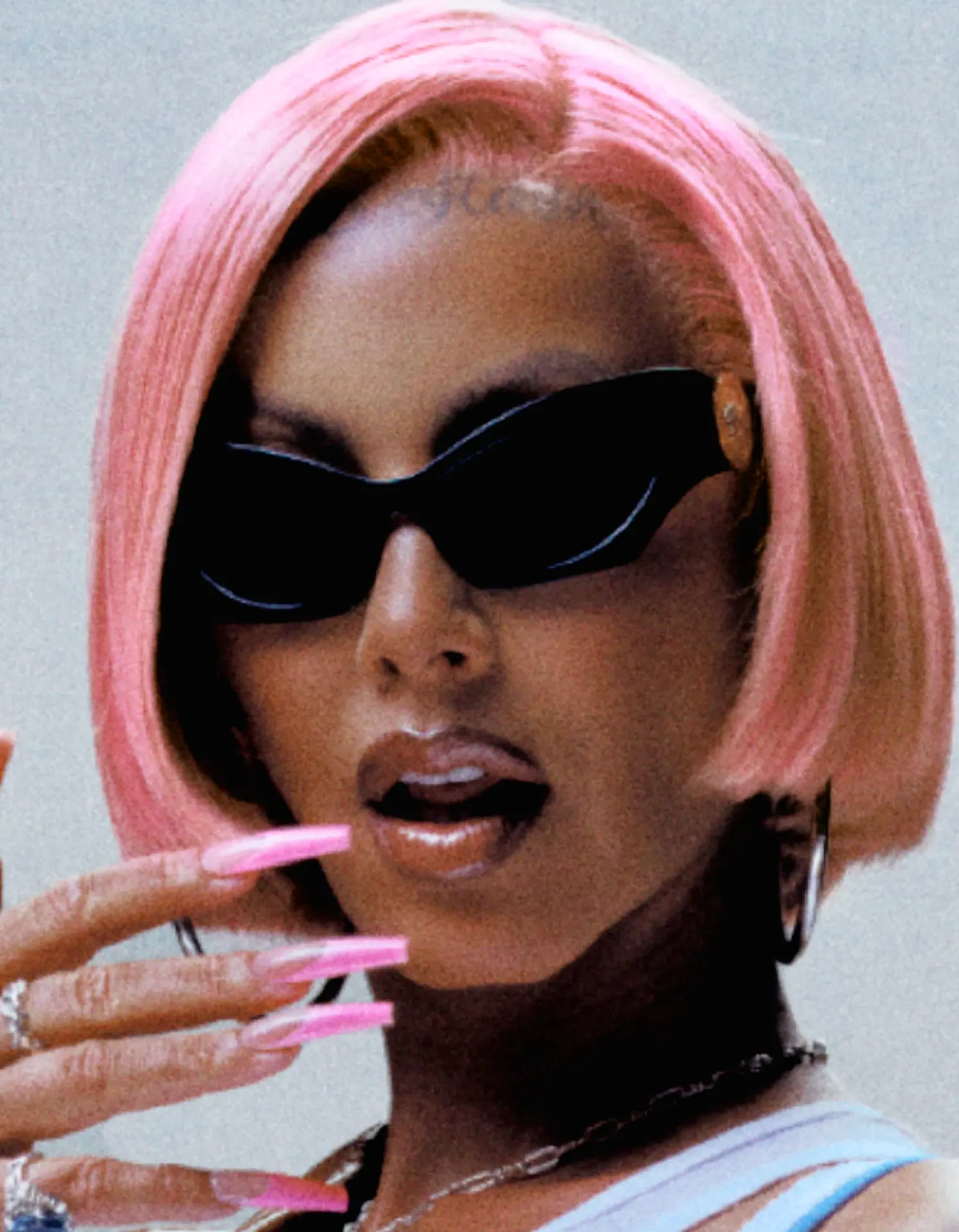 Amber Rose — close-up portrait with pink hair and black sunglasses