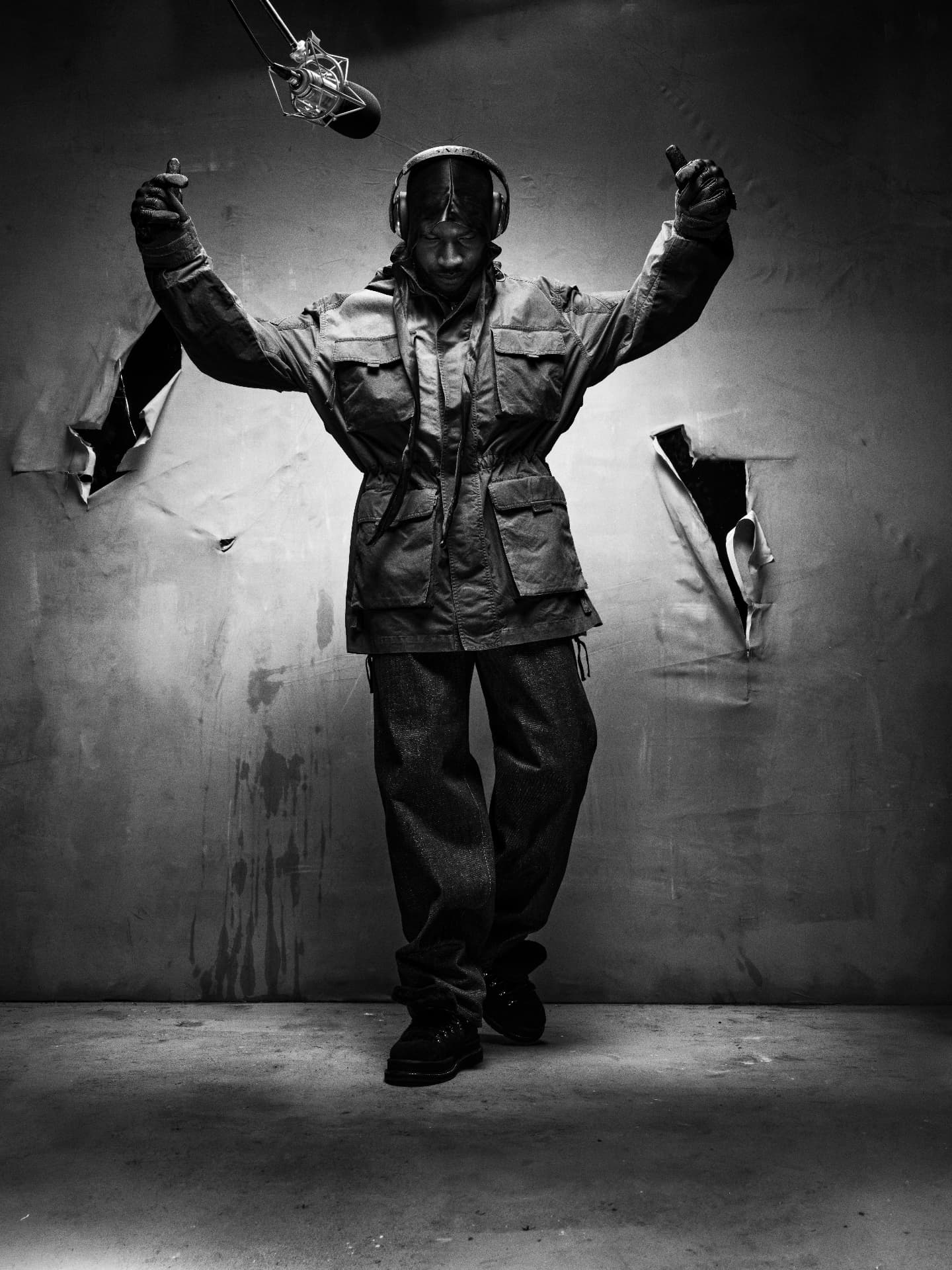 SKEPTA x GQ MOTY — black-and-white portrait in flight jacket with arms raised