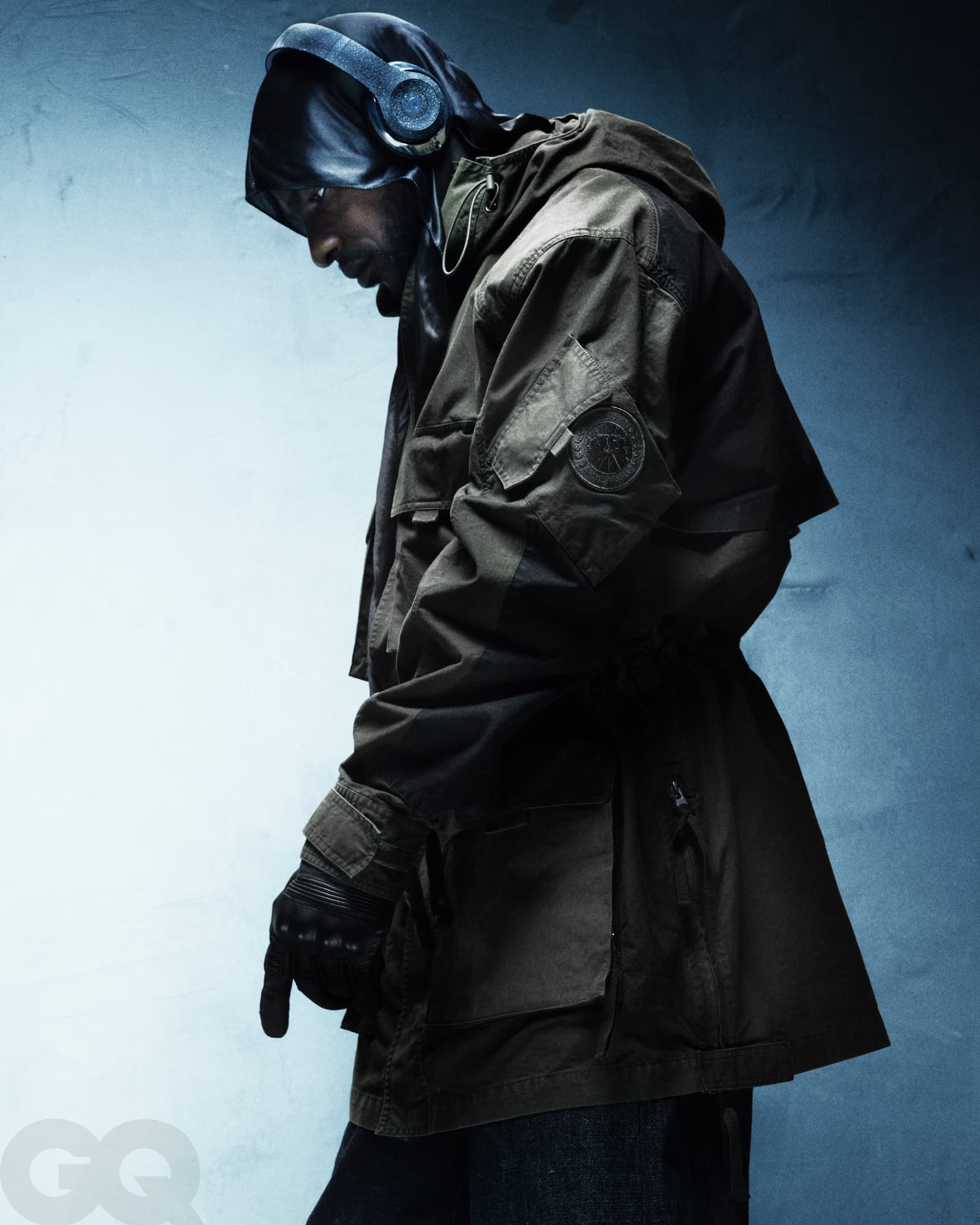 SKEPTA x GQ MOTY — hooded profile with headphones against blue light