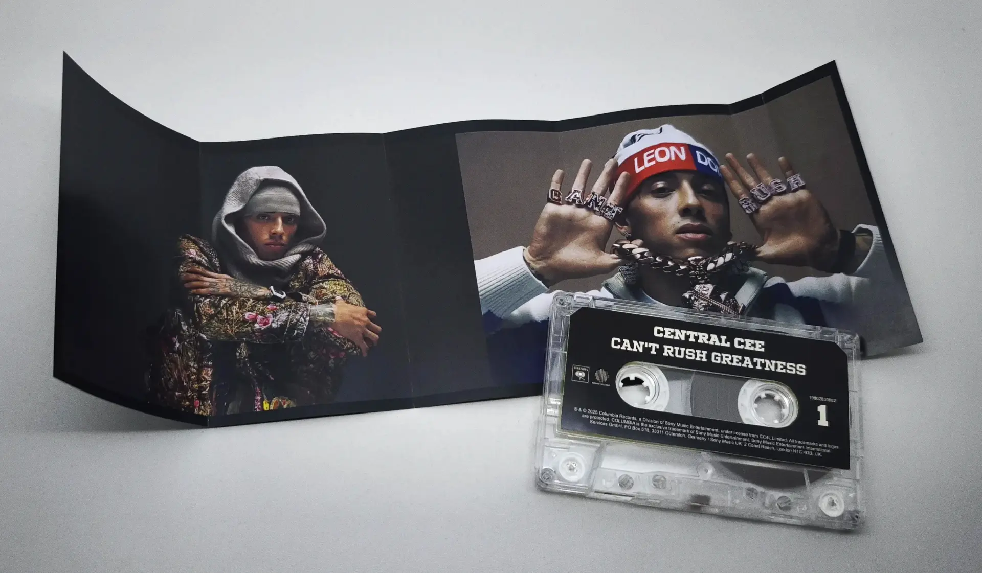 Central Cee — cityscape spread with camouflage parka and taped cassette artwork