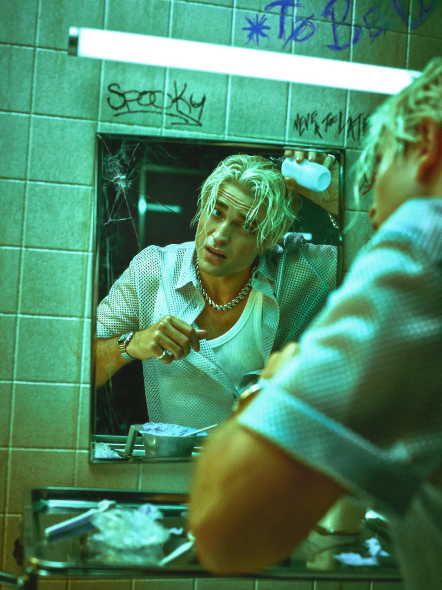 Rob Pattinson GQ — bathroom mirror portrait in green-blue light