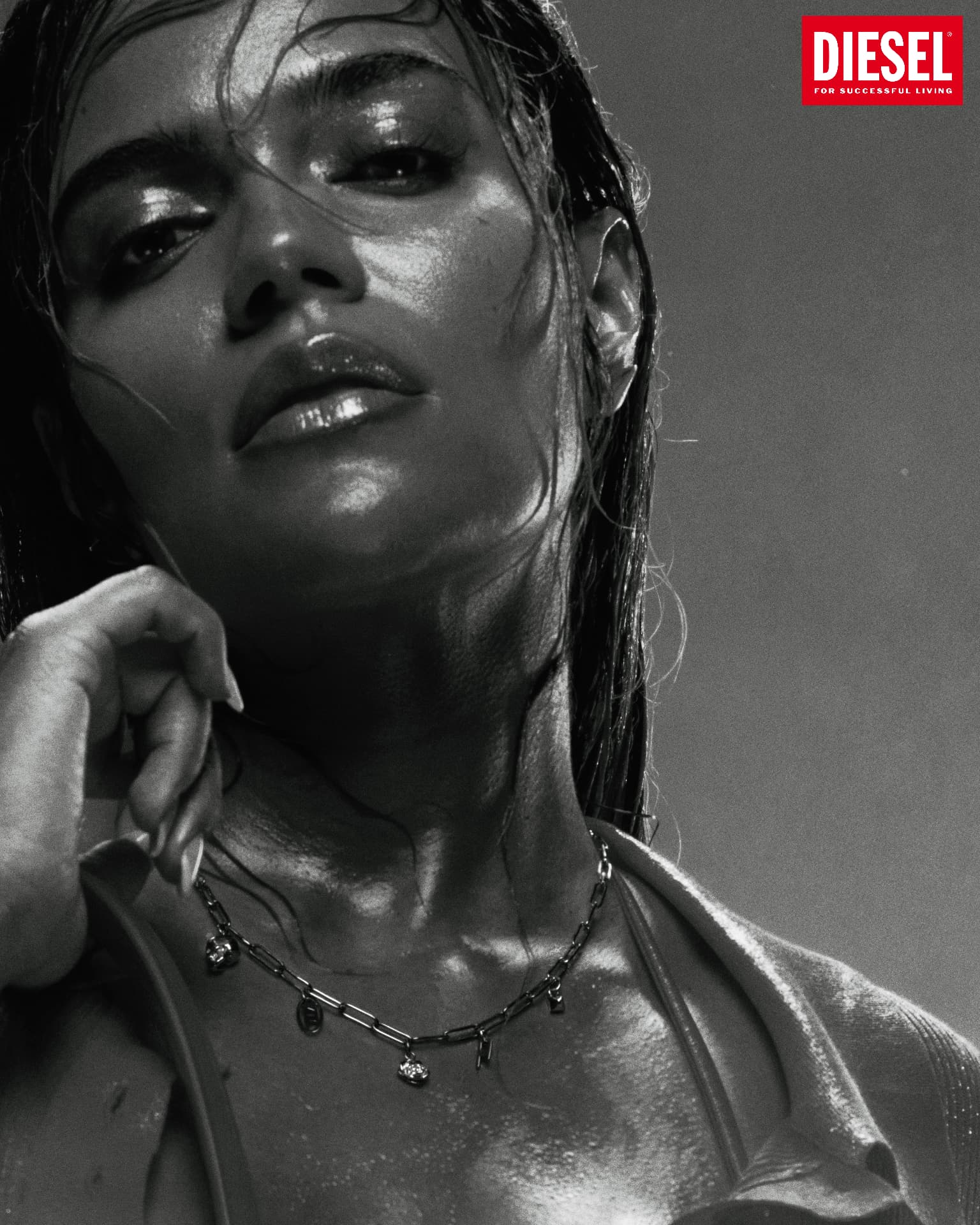 KAROL G x DIESEL — close-up black-and-white portrait with chain necklace and Diesel logo