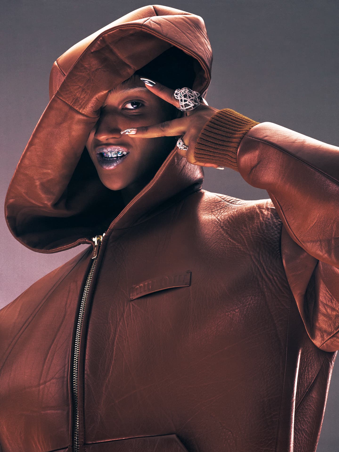 Georgia Palmer portrait in brown leather hooded jacket