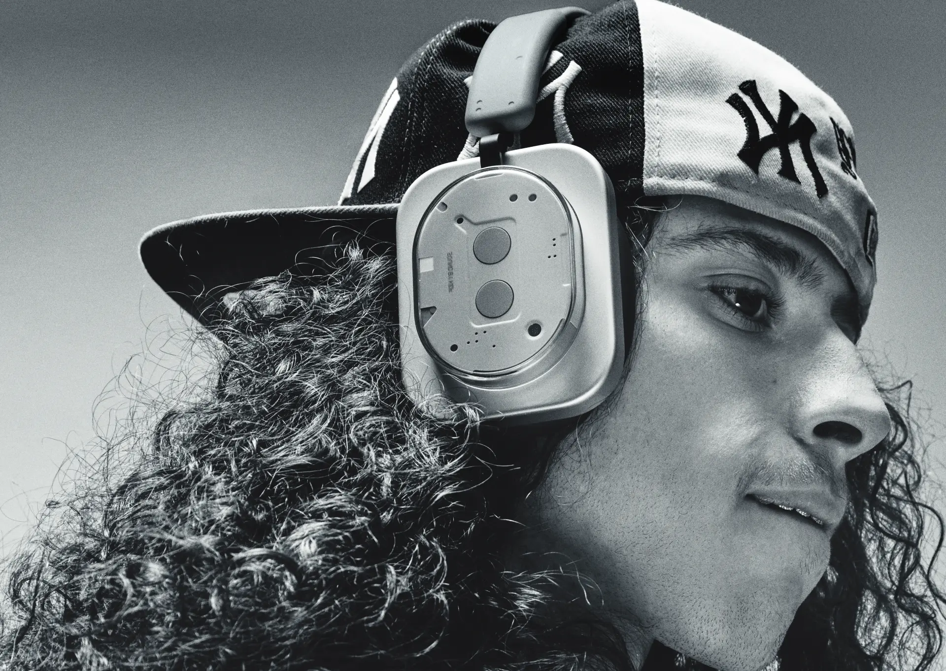Black and white portrait with Yankees cap and headphones