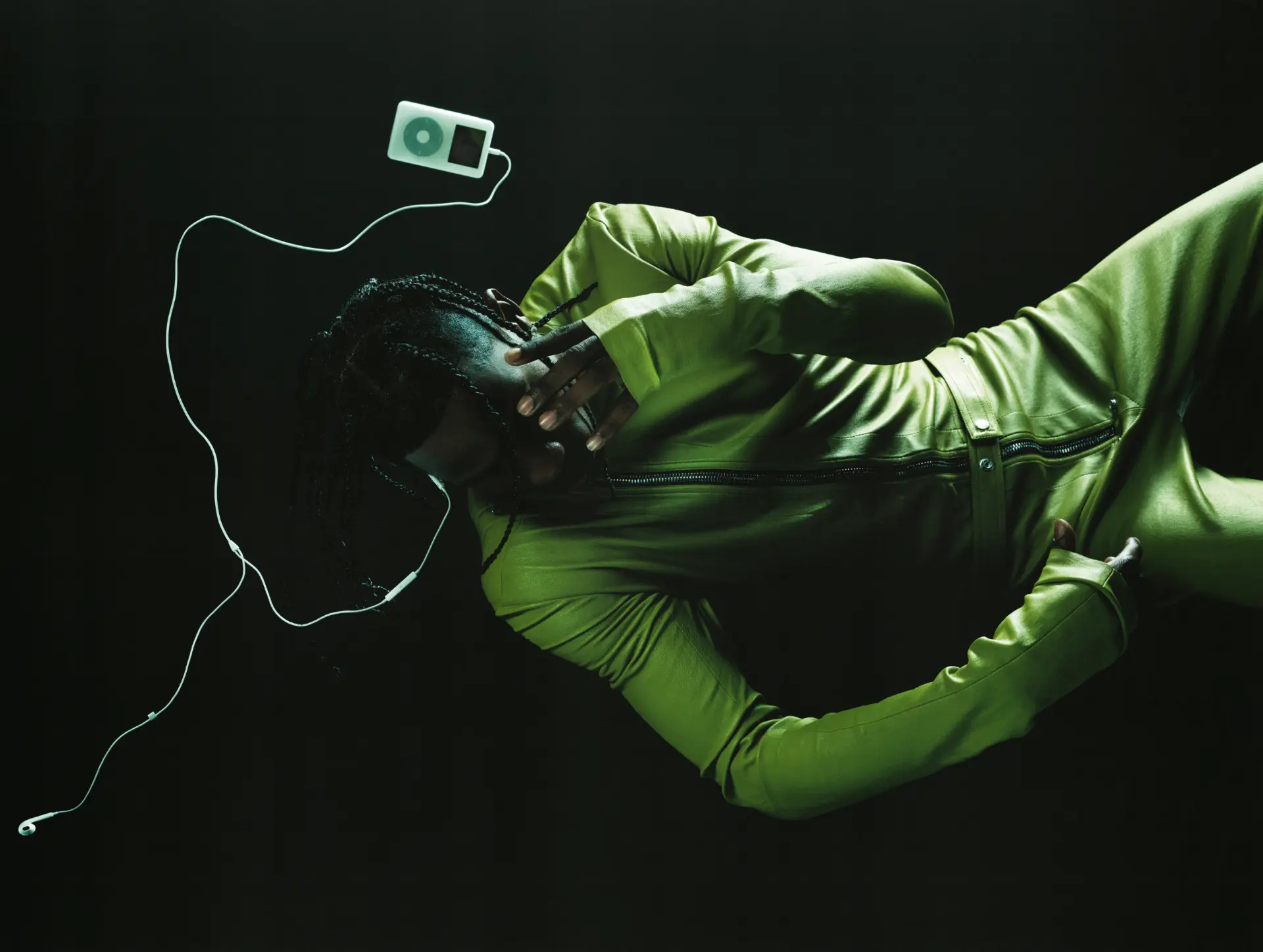 Travis Scott — figure in green leather jacket with iPod and earphones