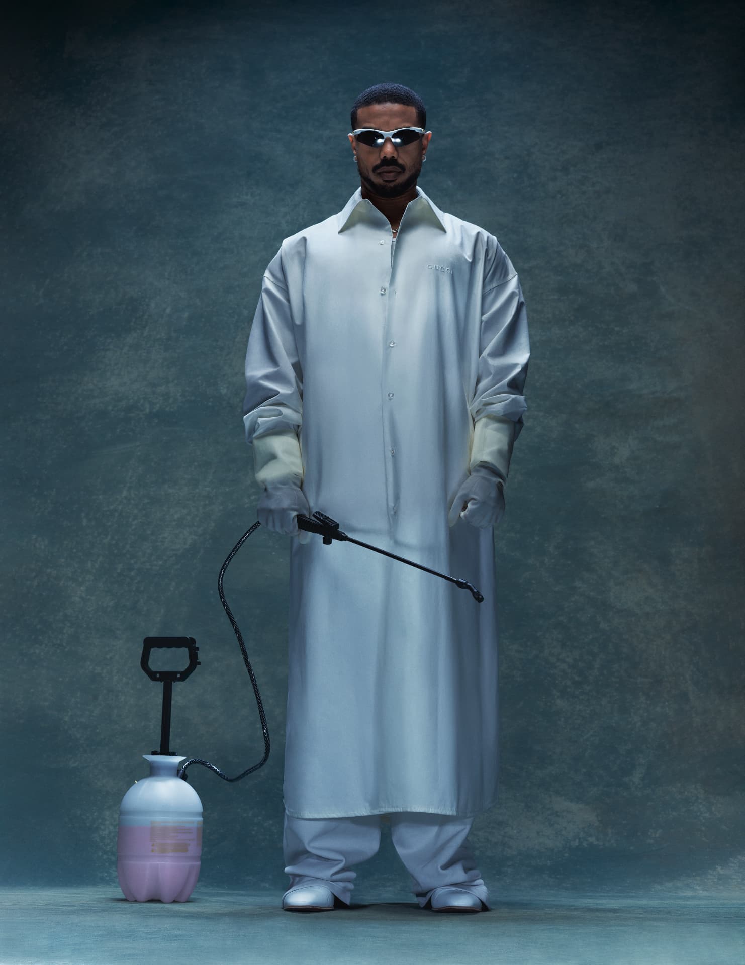 Michael B Jordan — standing in lab coat with sprayer