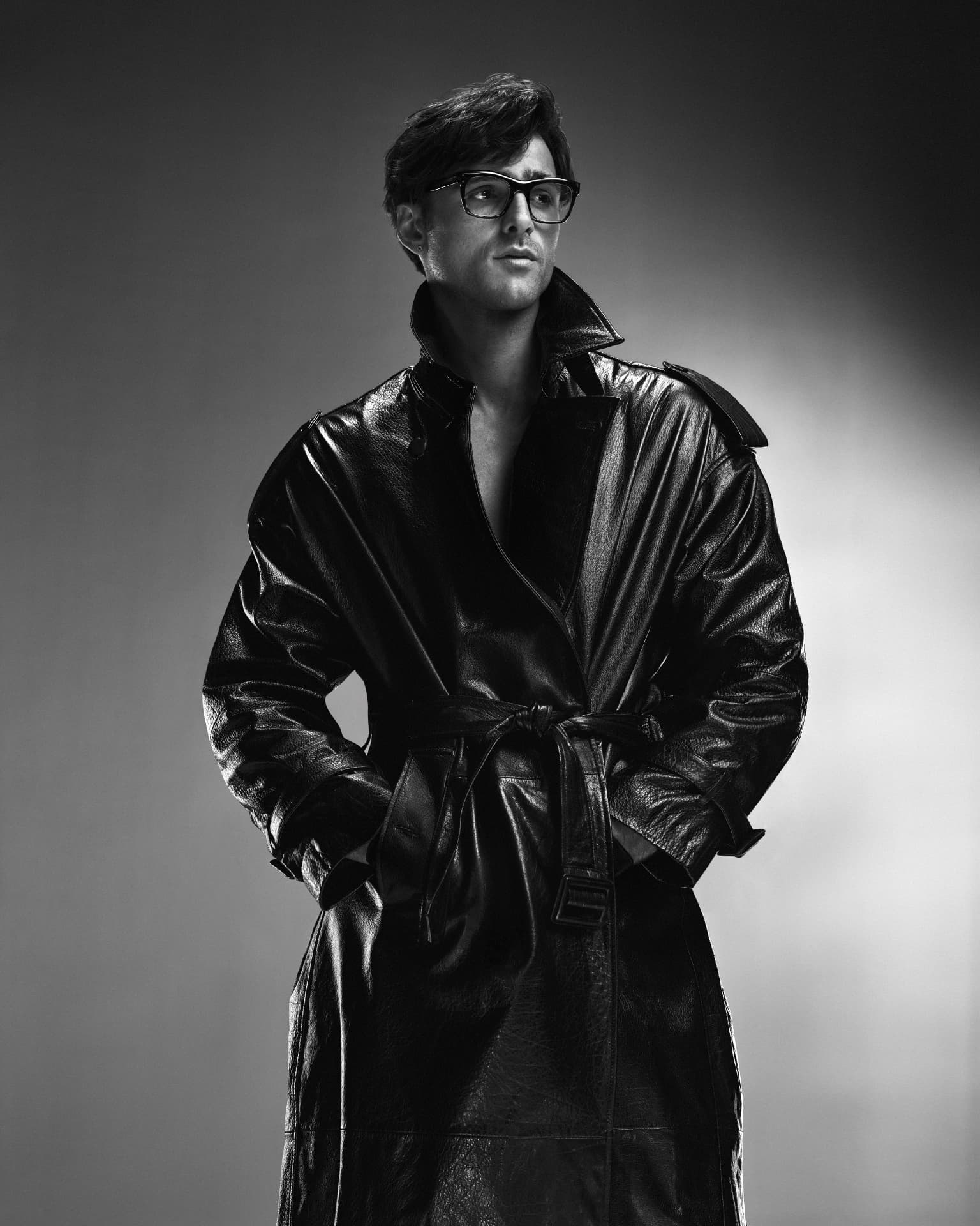 Jacob Elordi — black and white portrait in long leather coat and glasses