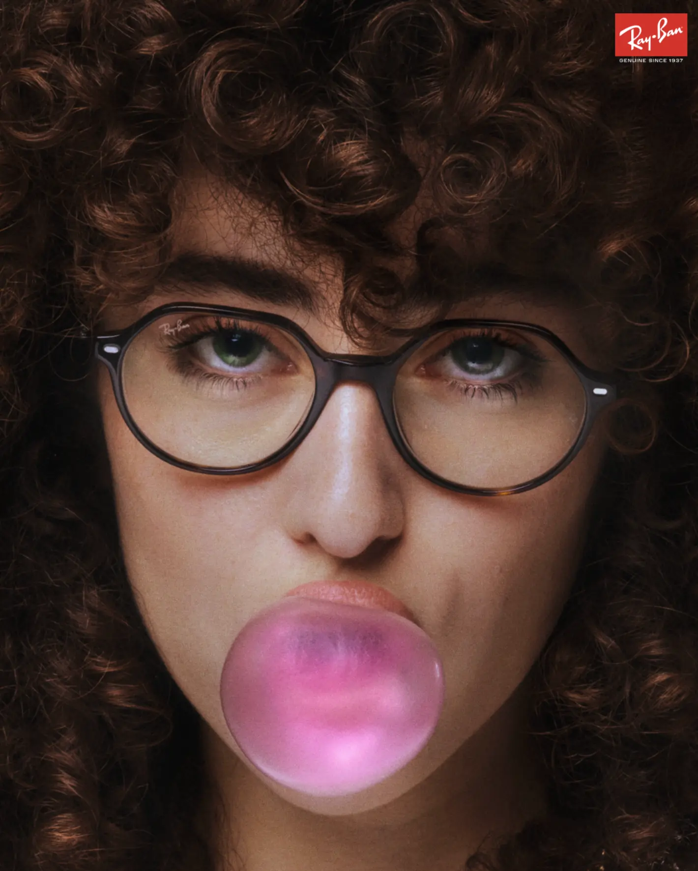 RayBan Holiday Campaign — curly-haired figure blowing a pink bubble-gum bubble