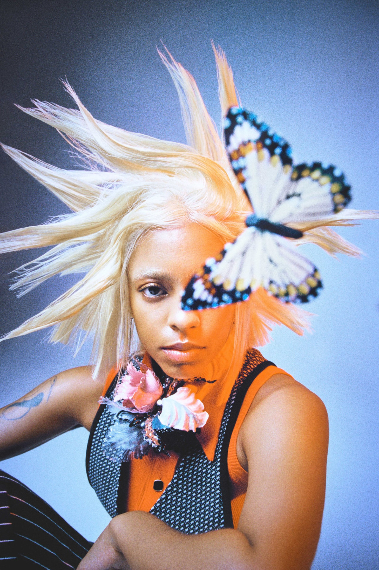 Kelsey Lu Numero portrait with butterfly and spiky blonde hair