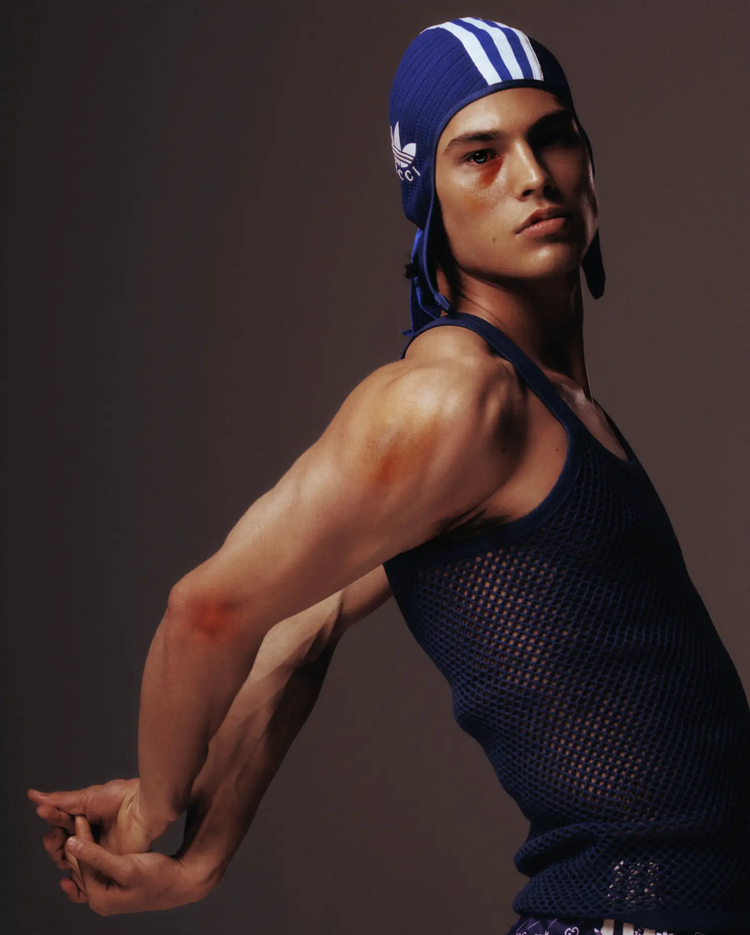 DUST Magazine — Alton Mason in blue Adidas x Gucci headpiece and mesh tank top